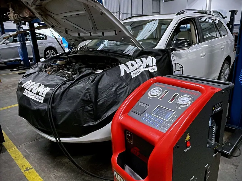 Equipamento de troca de óleo de câmbio Adami conectado a um carro no galpão